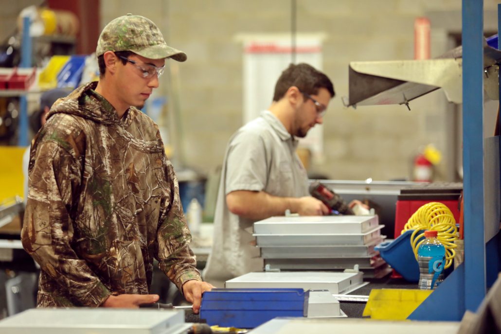 Two CHUTES International production workers in our manufacturing facility